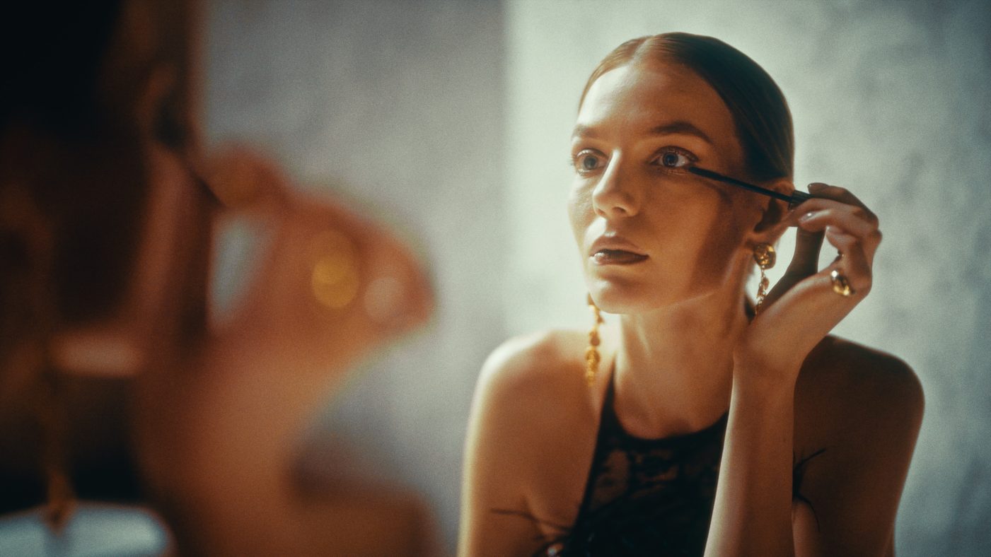 Produkcja filmów reklamowych Kraków | Motion Pikczer B2B 1 Kadr z produkcji Tubądzin x Maciej Zień: kobieta nakłada eyeliner w ciepłym świetle studyjnym. Premium spot komercyjny.